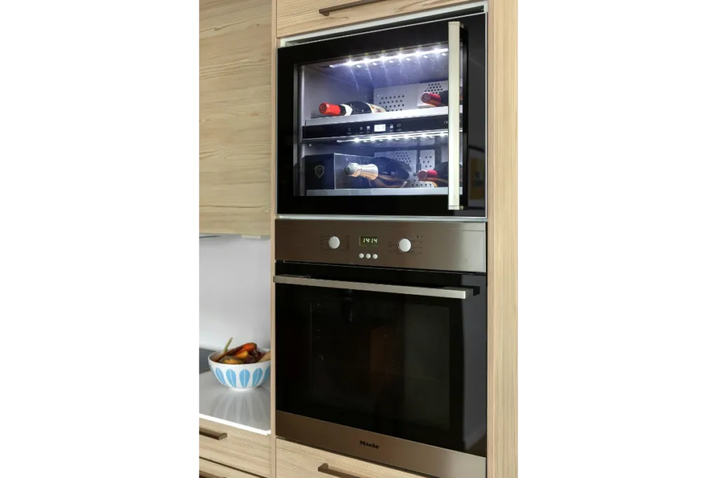A kitchen with a built-in oven and microwave