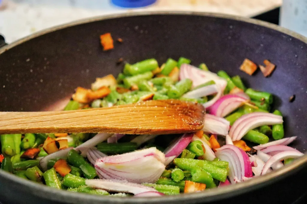 Someone is frying some veggies in a pan for Weeknight Dinners
