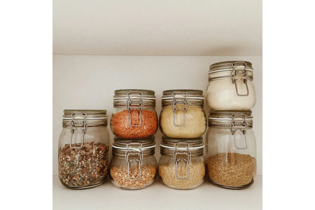 Some glass jars full of spices.