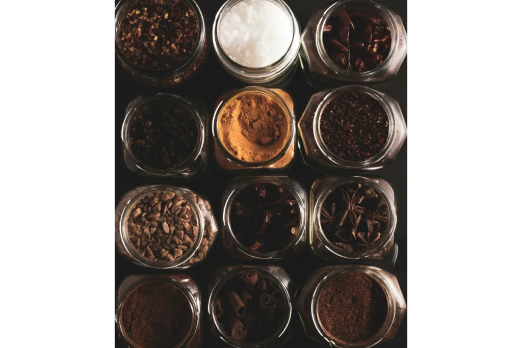 Upper shot of some glass jars full of spices