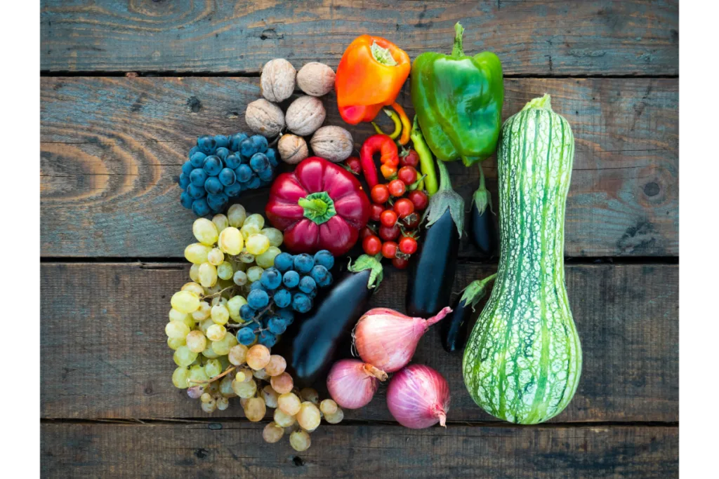 Bunch of veggies and fruits placed together.