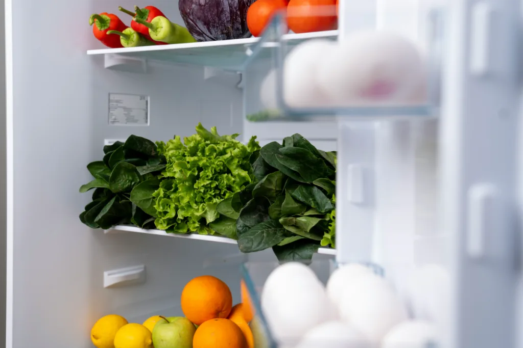 A fridge filled with day to day necessary veggies and fruits.