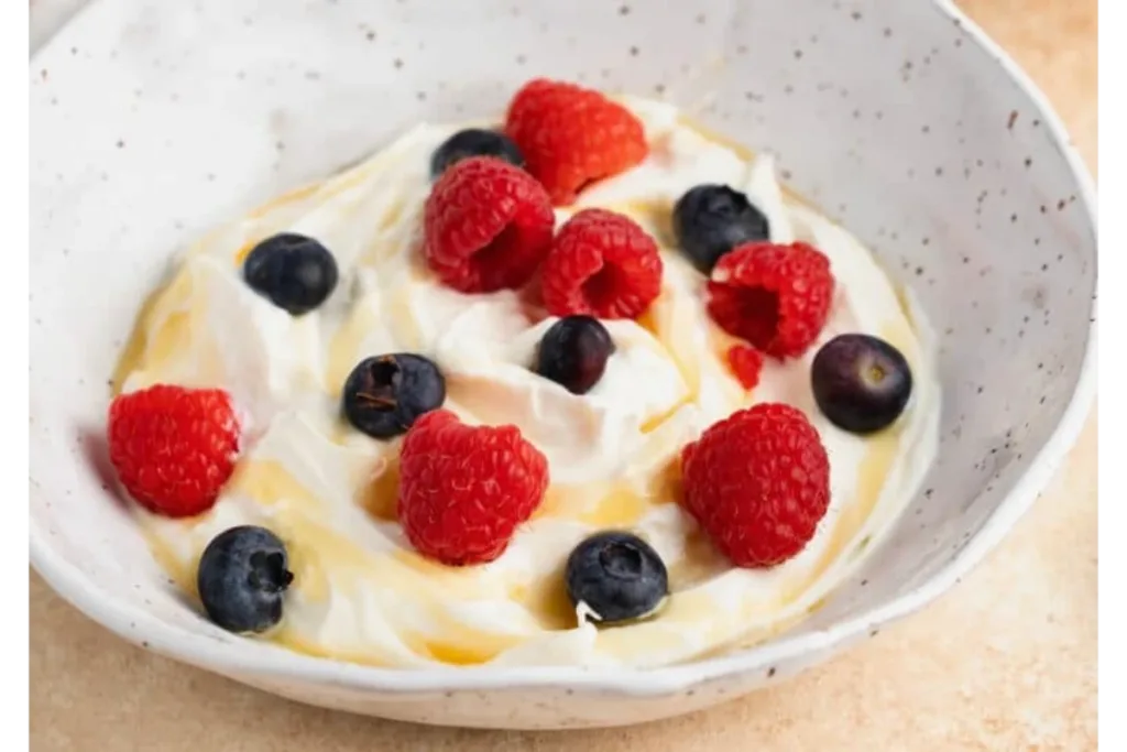 Geek Yoghurt in a white plate placed on a wooden table.