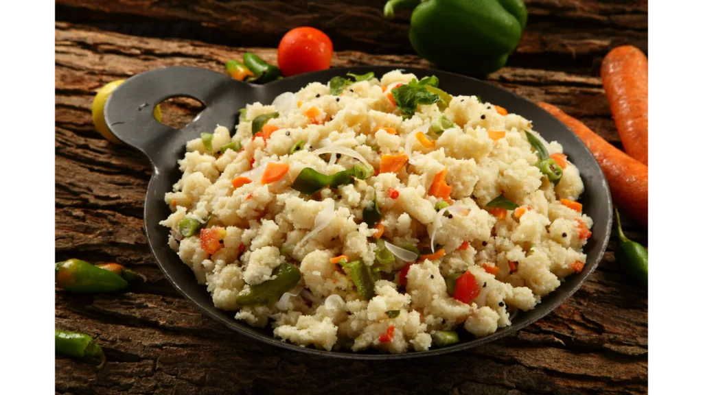 A bowl of soft and warm South Indian upma with vegetables, served with a side of chutney.