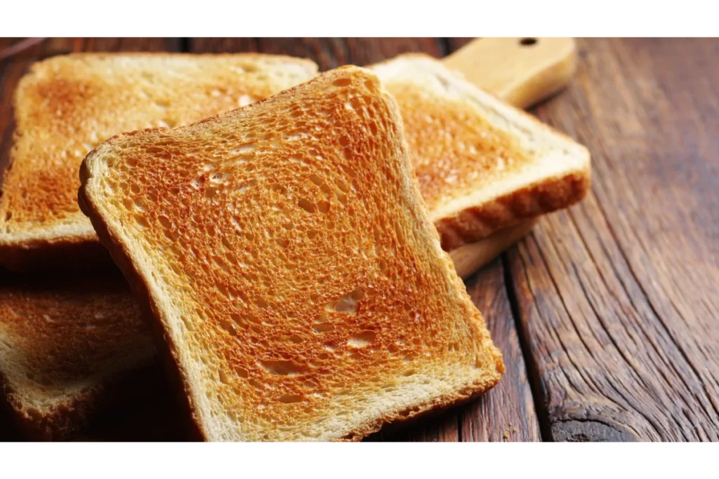 Toasted bread placed on a wooden bench- avocado toast recipe