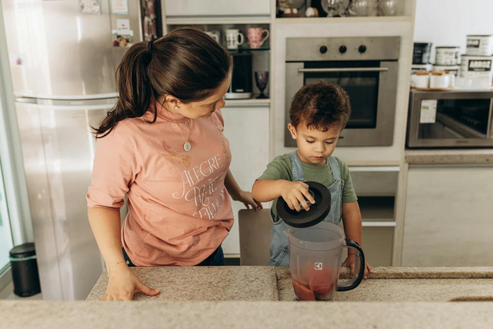 Child washing fruits, practicing kitchen safety for kids.