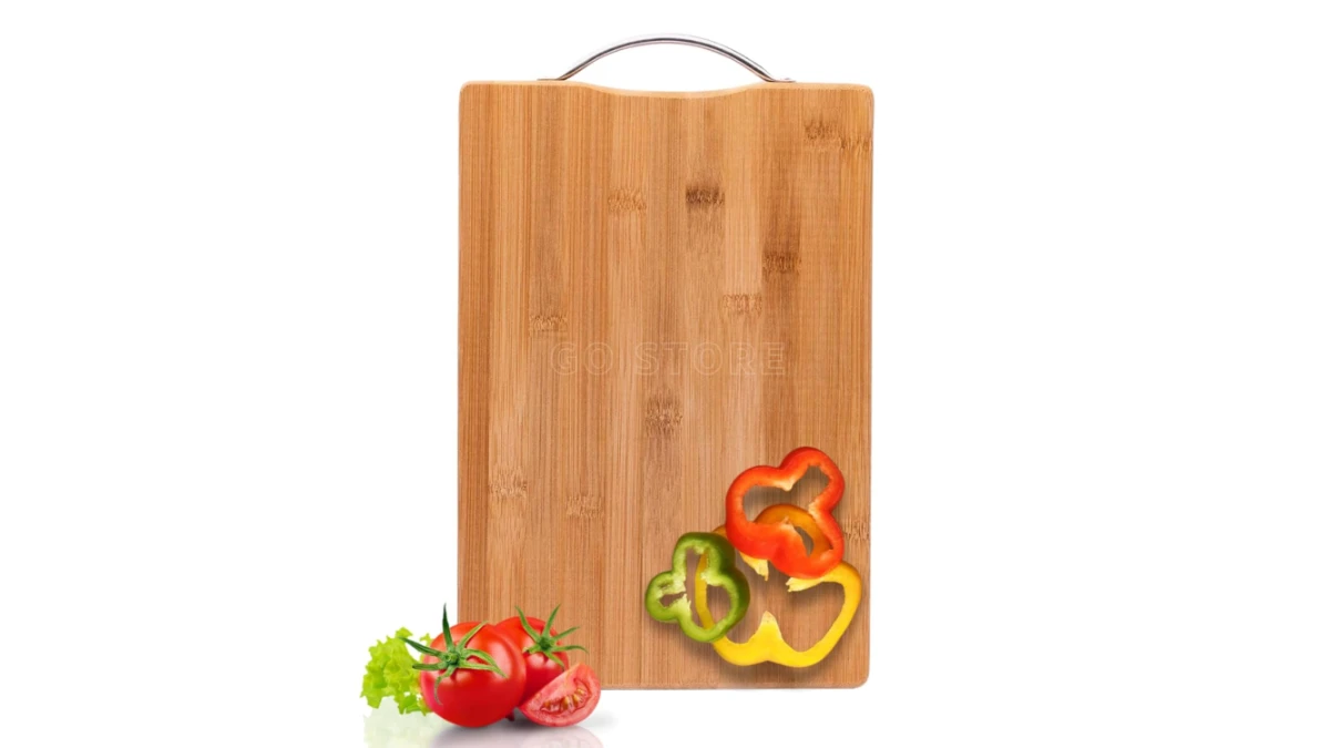 A chef slicing tomatoes on a sturdy chopping board.