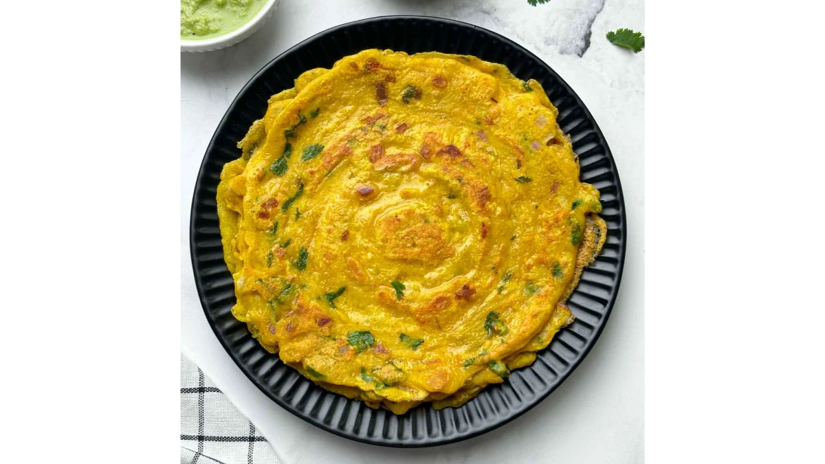 Crispy golden-brown Moong Dal Chilla served on a plate.